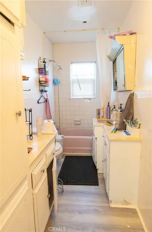 a bathroom with a sink a tub and a mirror