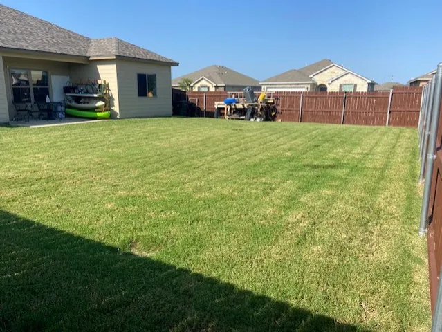 a view of a house with a yard and a car park fire pit