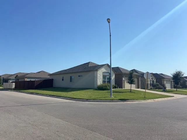 a front view of a house with a garden and trees