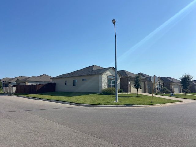 4748 Highmont Drive Temple, TX 76502 - Photo 2 of 12 a front view of a house with a garden and trees