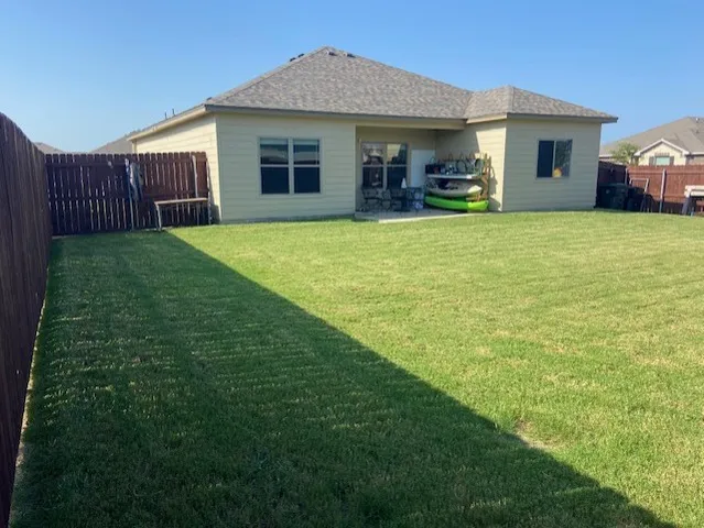 a view of a house with a yard and sitting area