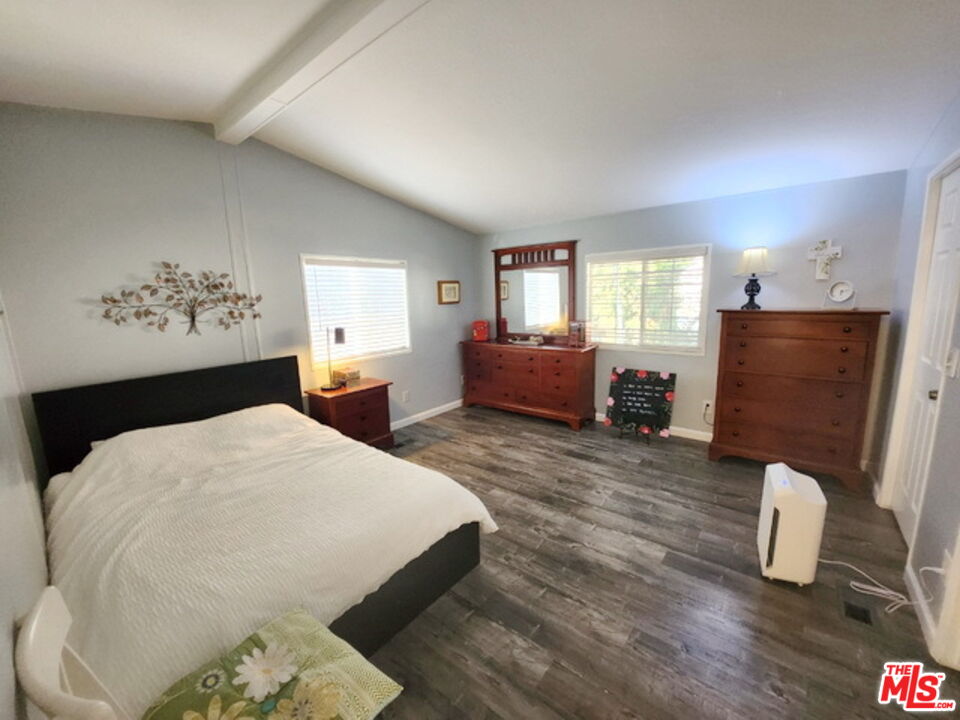 1051 Site Drive, Unit 209 Brea, CA 92821 - Photo 13 of 18 a bedroom with bed and wooden floor