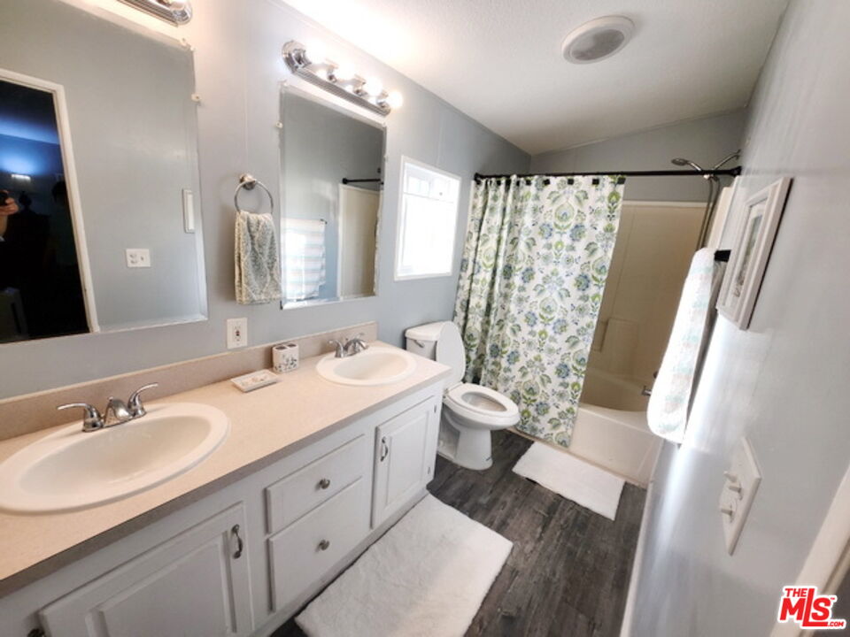 1051 Site Drive, Unit 209 Brea, CA 92821 - Photo 14 of 18 a spacious bathroom with a double vanity sink toilet and shower