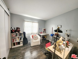 1051 Site Drive, Unit 209 Brea, CA 92821 - Photo 15 of 18 a bedroom with furniture and a wooden floor