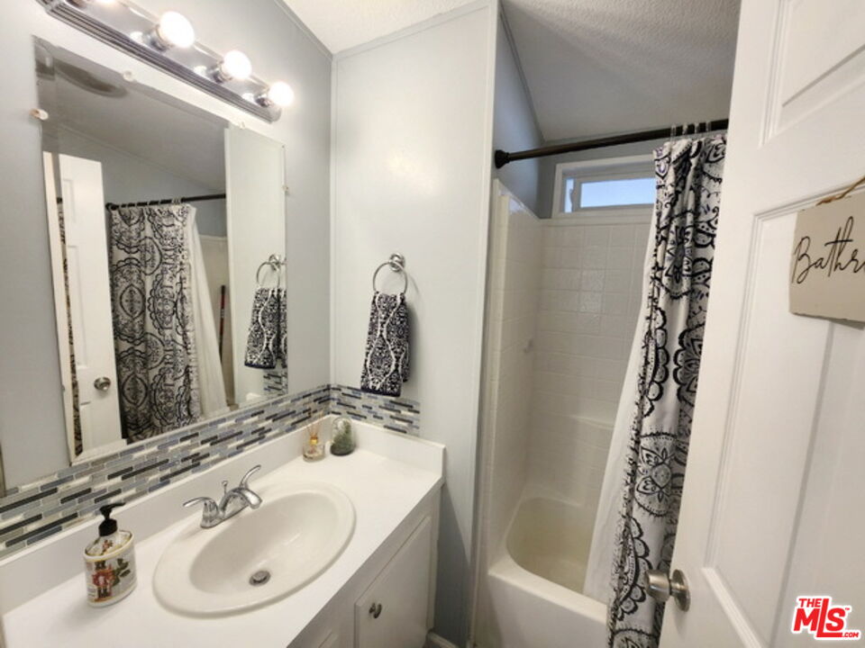 1051 Site Drive, Unit 209 Brea, CA 92821 - Photo 17 of 18 a bathroom with a sink and a mirror