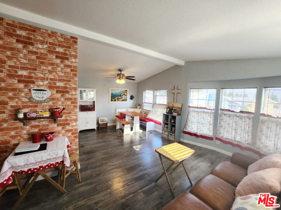 1051 Site Drive, Unit 209 Brea, CA 92821 - Photo 6 of 18 a living room with furniture and a floor to ceiling window