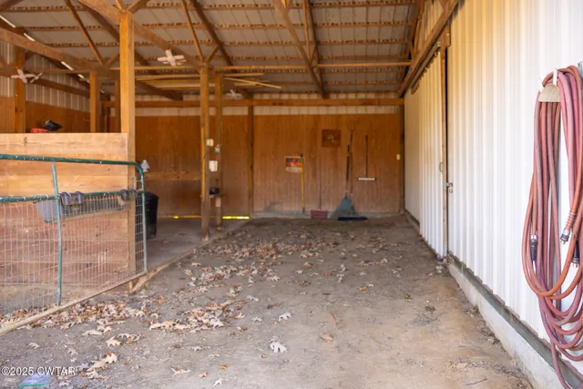 a view of empty room with floor to ceiling window and wooden floor