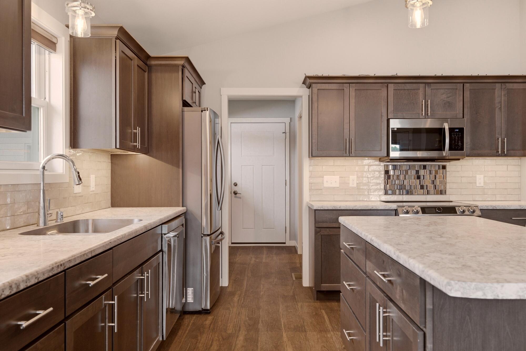 1709 Killdeer Street Holmen, WI 54636 - Photo 7 of 26 Kitchen w/ island and under cabinet lighting