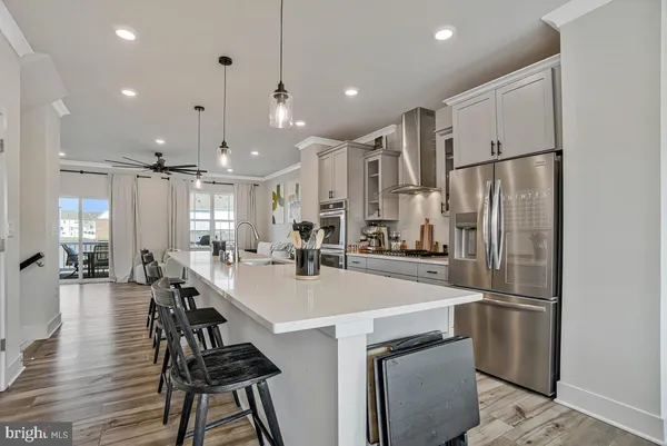 a kitchen with refrigerator and chairs