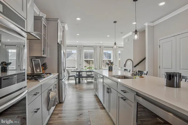 a kitchen with lots of counter space a sink appliances and cabinets