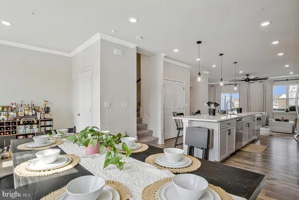 a kitchen with stainless steel appliances kitchen island granite countertop a sink and white cabinets