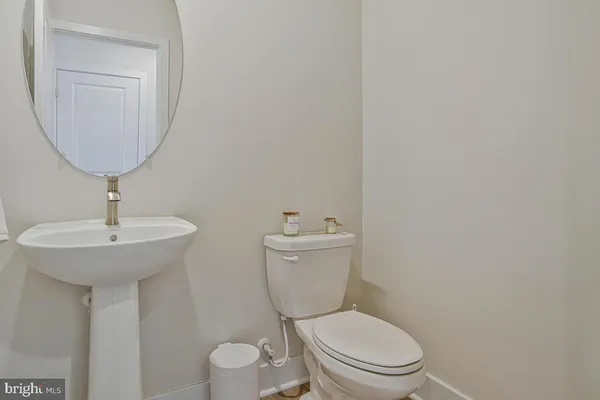 a bathroom with a toilet a sink and a mirror