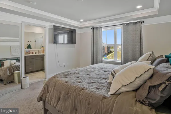 a bedroom with a bed and a television