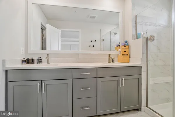 a bathroom with a sink vanity and mirror