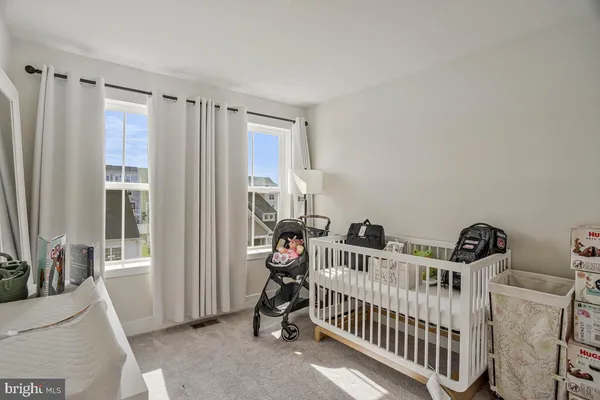 a view of a hallway with closet and wooden floor