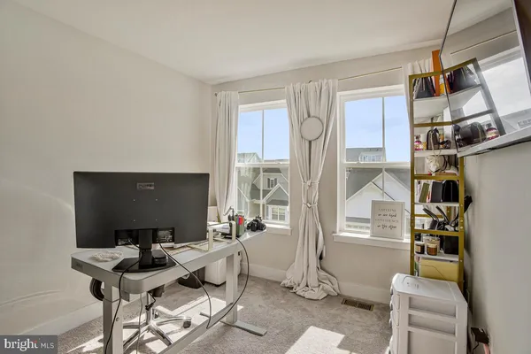 a living room with furniture a flat screen tv and a table