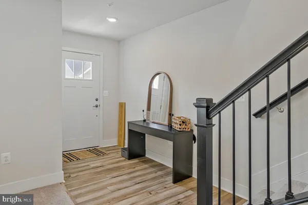 a view of a bedroom with wooden floor and stairs