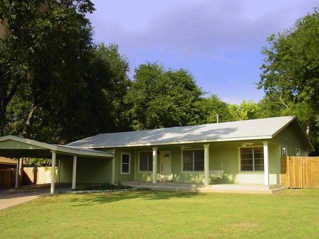 6317 Wild Street Austin, TX 78757 - Photo 1 of 1 a front view of a house with a yard