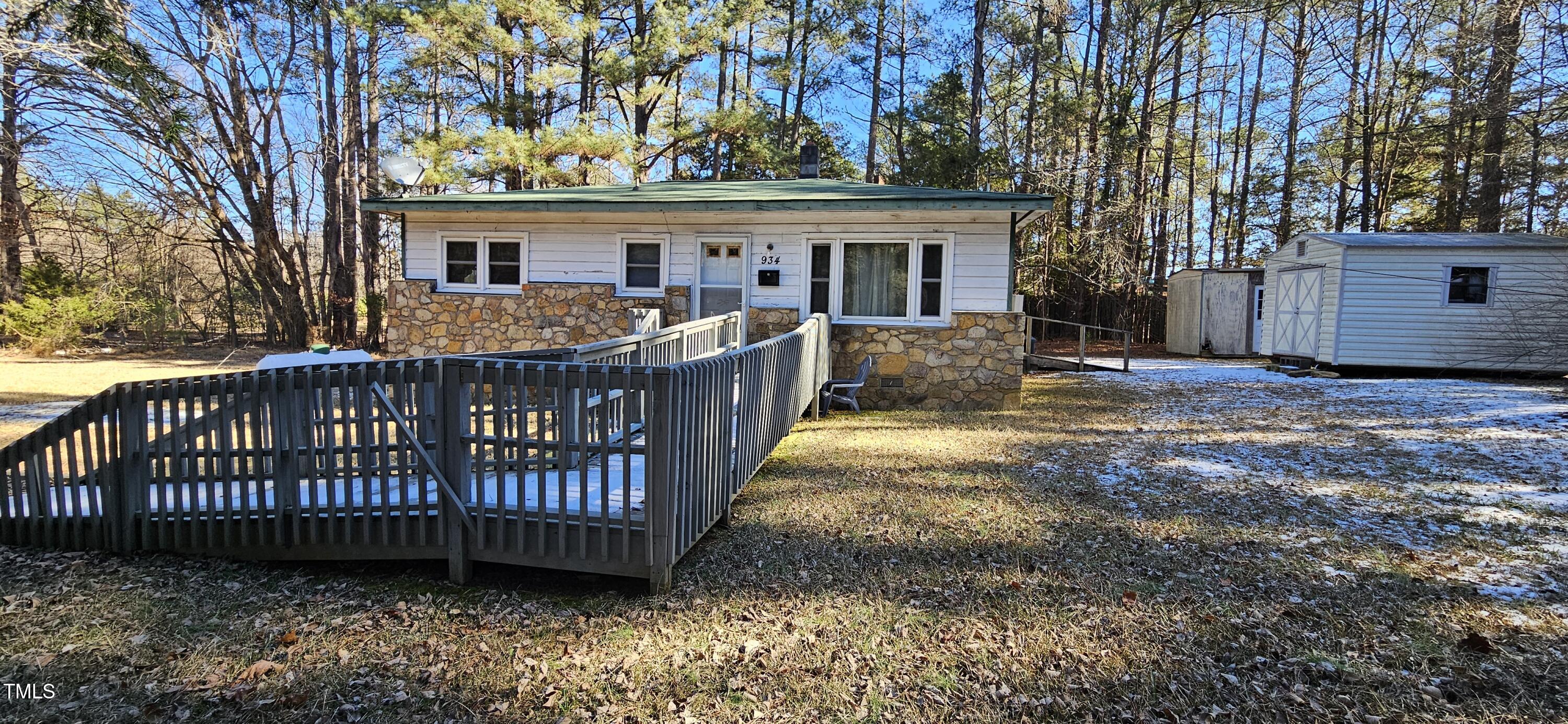 934 Shady Lawn Road Chapel Hill, NC 27514 - Photo 1 of 8 a view of a house with a wooden deck and a yard