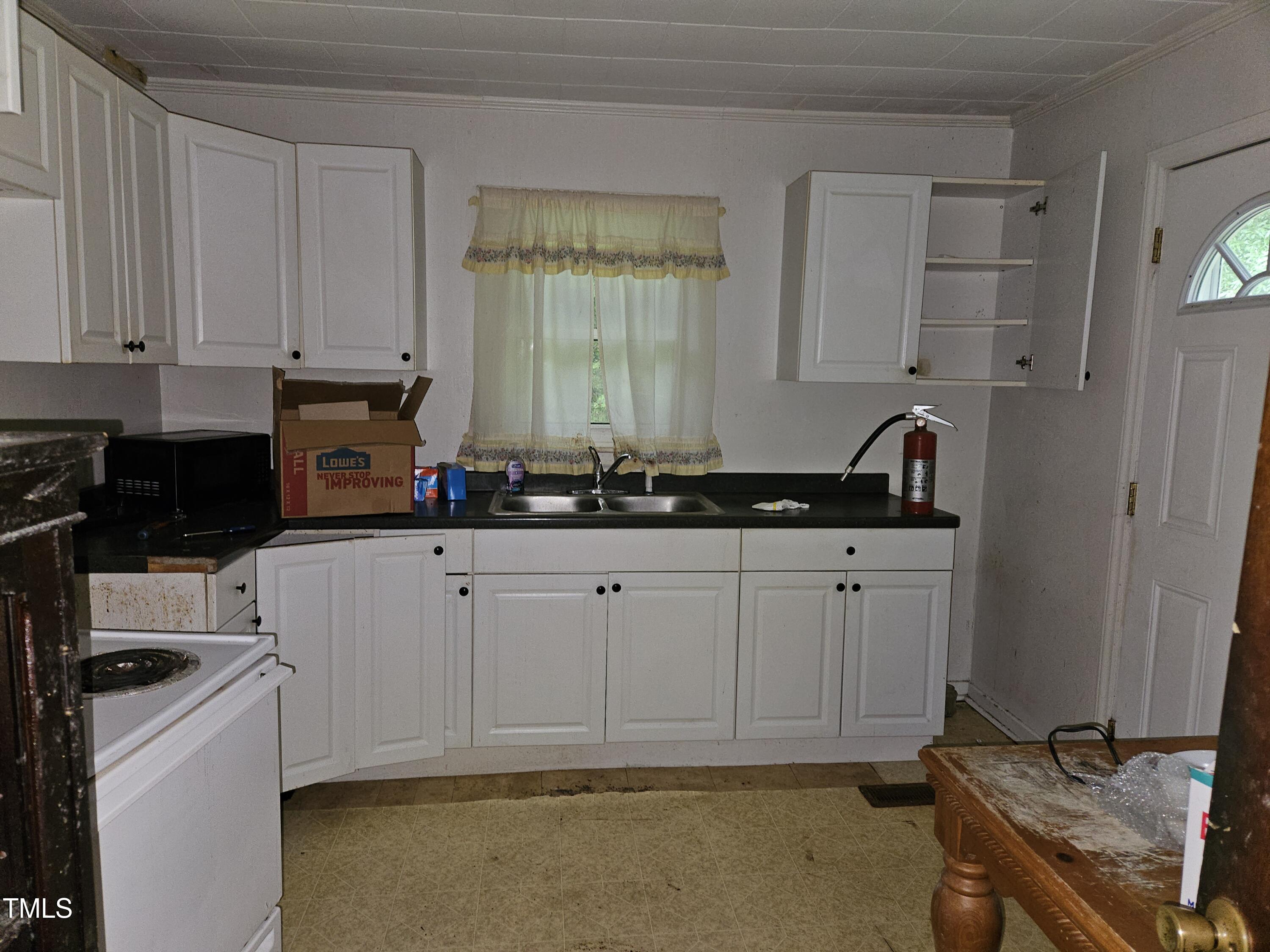 934 Shady Lawn Road Chapel Hill, NC 27514 - Photo 5 of 8 a kitchen with granite countertop a sink a stove and cabinets