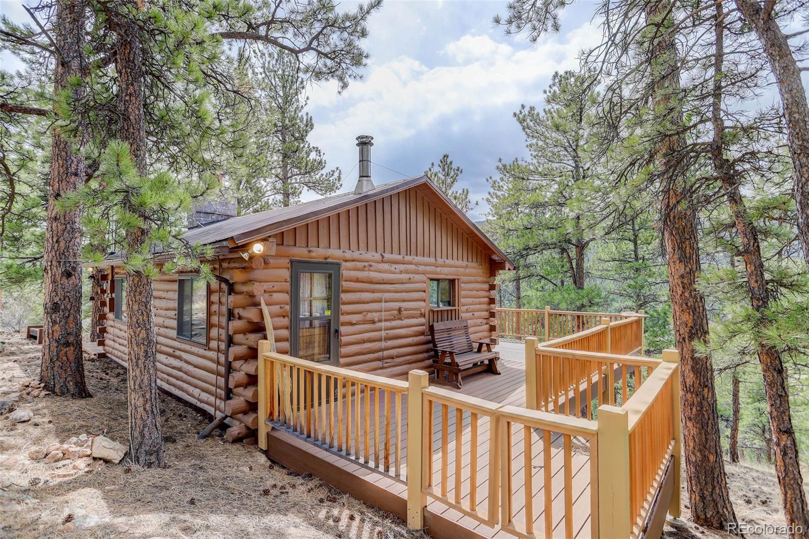 Undisclosed Address Bailey, CO 80421 - Photo 1 of 21 a view of a roof deck with wooden fence and trees