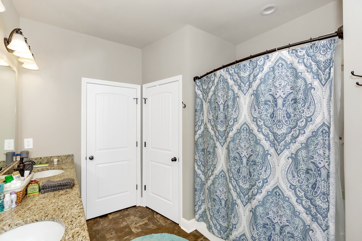 247 Mabel Hill Road Toney, AL 35773 - Photo 17 of 29 a bathroom with a sink and shower curtain