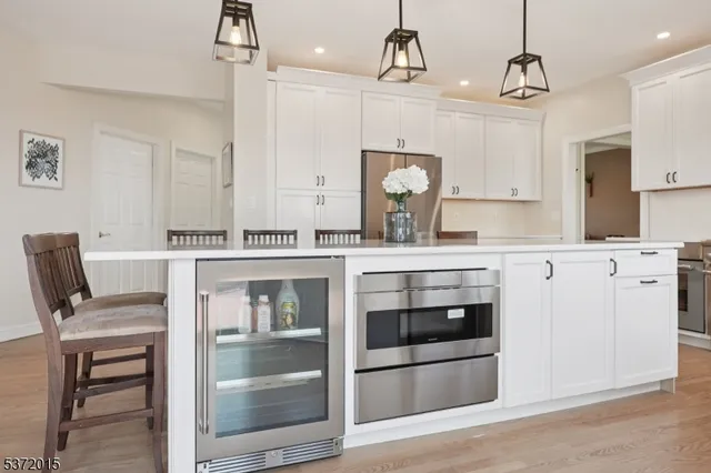 a kitchen with a stove and white cabinets