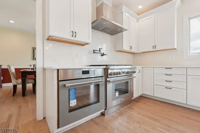 a stove top oven sitting inside of a kitchen