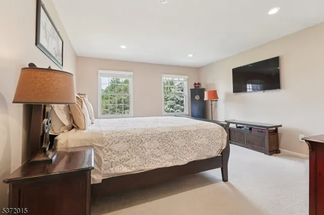 a bedroom with a large bed and a flat screen tv