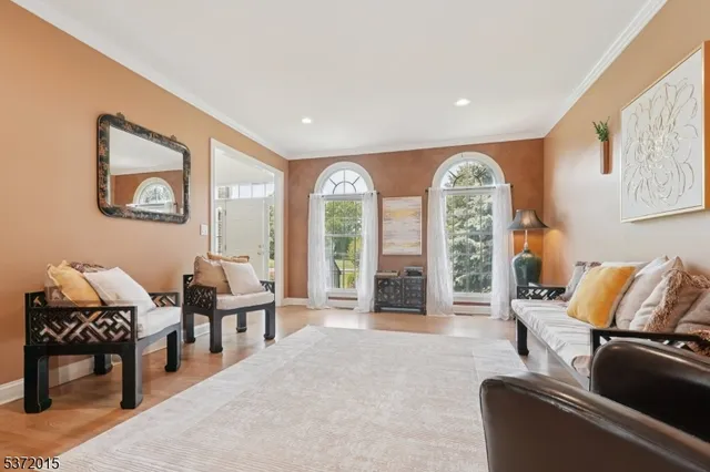 a living room with furniture and large windows