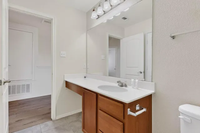 a bathroom with a sink vanity and a mirror
