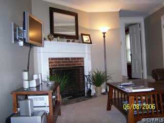 4808 Morrison Road Richmond, VA 23230 - Photo 4 of 8 a living room with furniture a flat screen tv and a fireplace