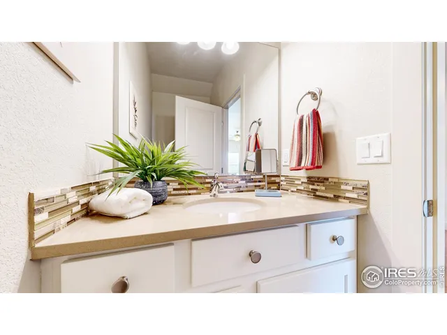 a bathroom with a sink a vanity and mirror
