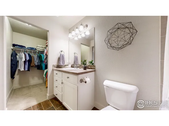 a bathroom with a toilet a sink and a mirror