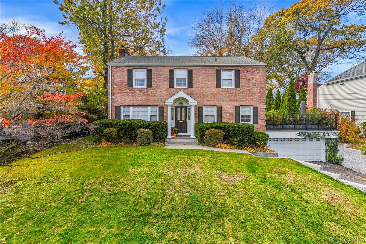 a front view of a house with garden and porch