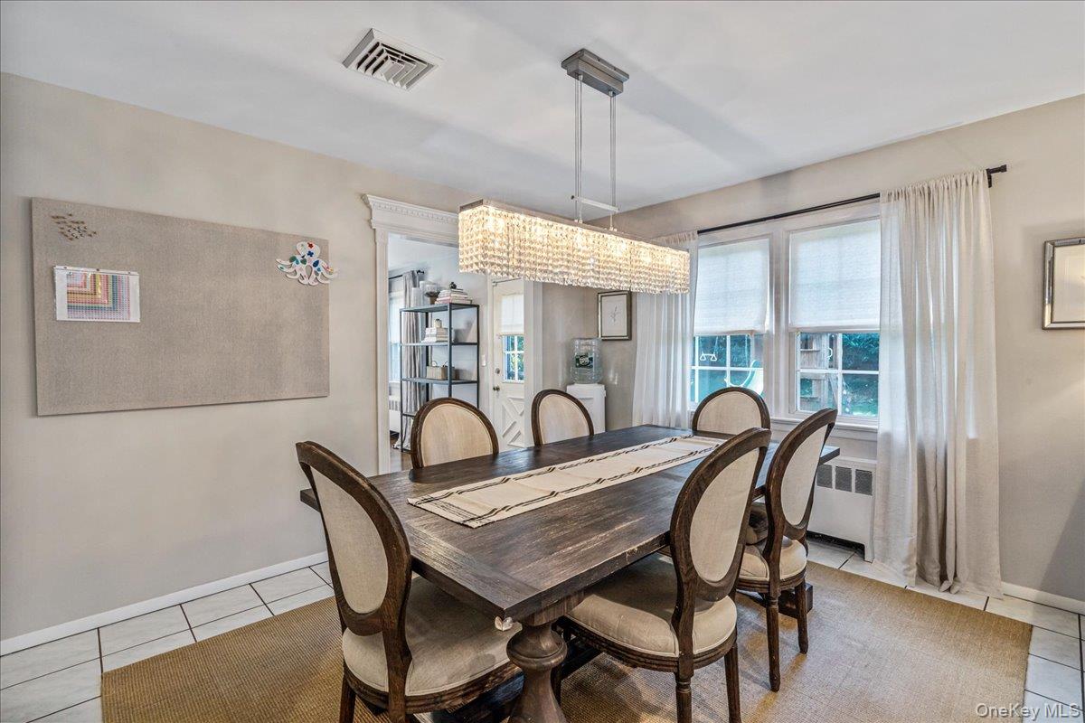 53 Stuart Place Manhasset, NY 11030 - Photo 11 of 32 a view of a dining room with furniture window and wooden floor