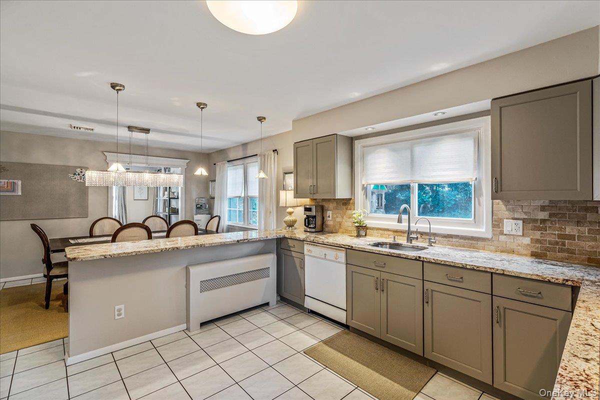 53 Stuart Place Manhasset, NY 11030 - Photo 13 of 32 a kitchen with a sink and cabinets