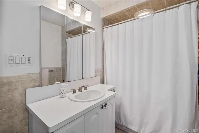 a bathroom with a granite countertop sink toilet and a mirror
