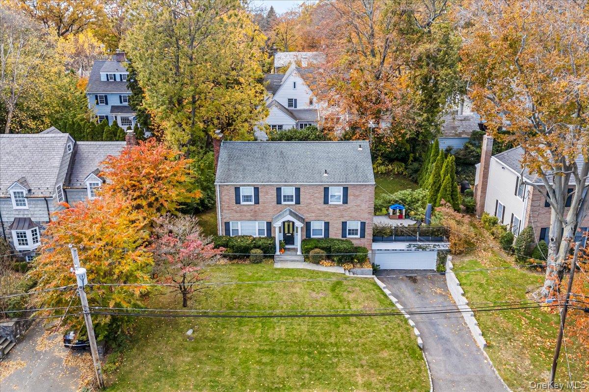 53 Stuart Place Manhasset, NY 11030 - Photo 2 of 32 front view of house with a yard
