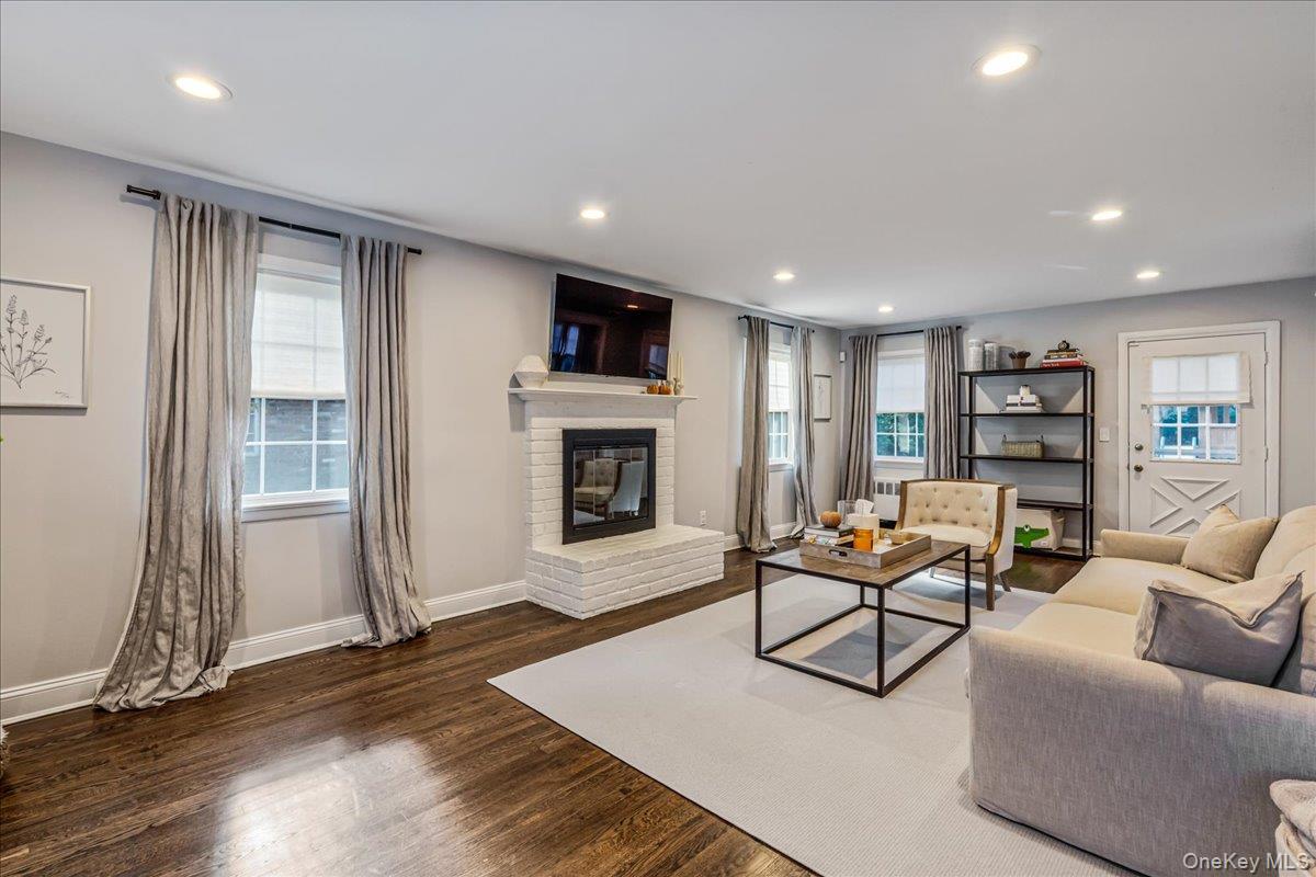53 Stuart Place Manhasset, NY 11030 - Photo 7 of 32 a living room with furniture and a fireplace