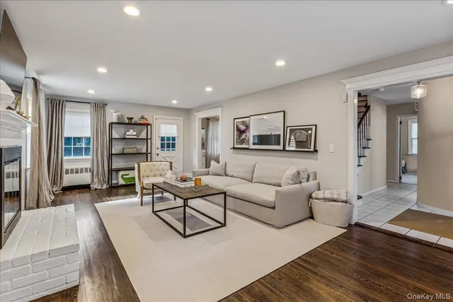 a living room with furniture a window and a fireplace