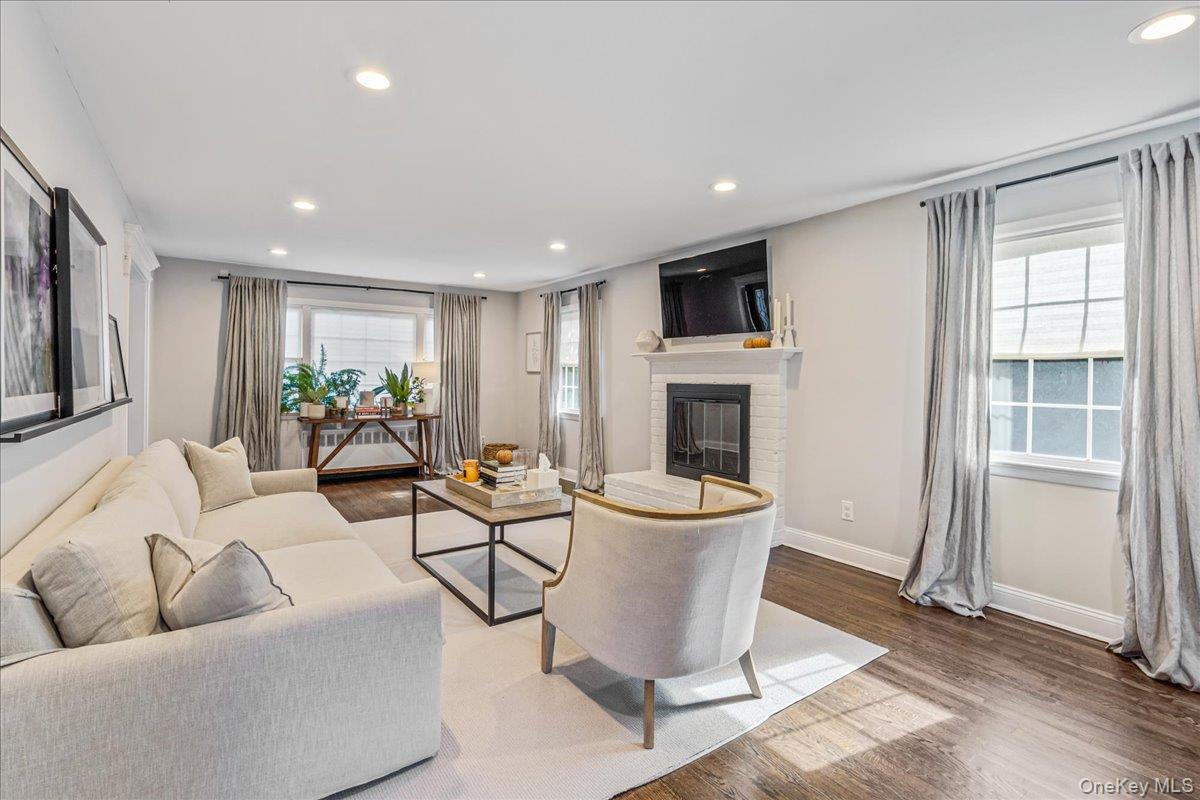 53 Stuart Place Manhasset, NY 11030 - Photo 9 of 32 a living room with furniture a window and a fireplace
