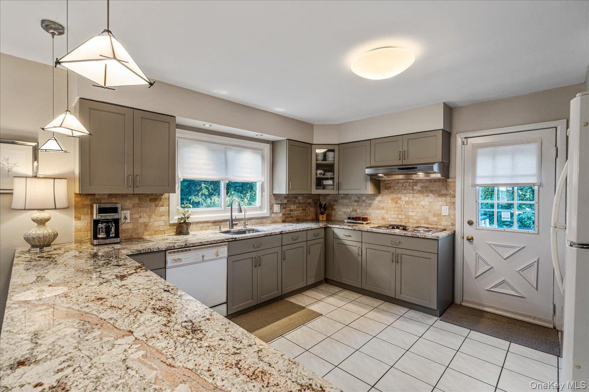 53 Stuart Place Manhasset, NY 11030 - Photo 10 of 32 a kitchen with granite countertop appliances cabinets and a sink