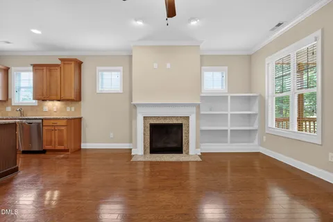 a view of a livingroom with a fireplace and window