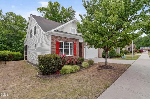 a flower garden is sitting in front of a house