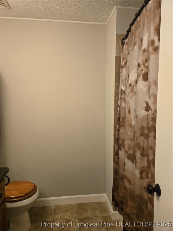 3324 Balero Court Spring Lake, NC 28390 - Photo 16 of 26 a bathroom with a toilet and a shower curtain