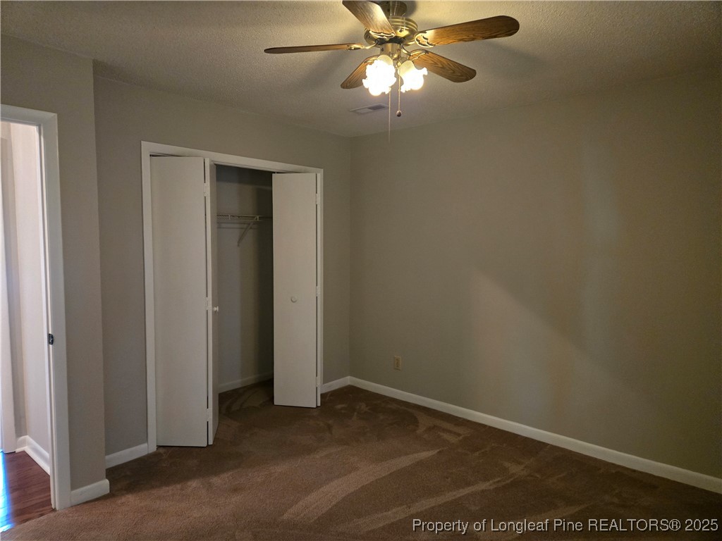3324 Balero Court Spring Lake, NC 28390 - Photo 19 of 26 an empty room with wooden floor chandelier fan and closet area