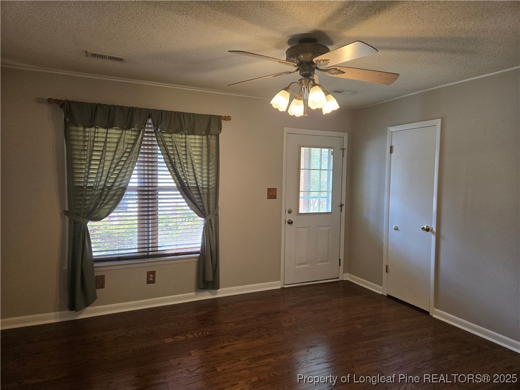 3324 Balero Court Spring Lake, NC 28390 - Photo 8 of 26 an empty room with wooden floor fan and windows