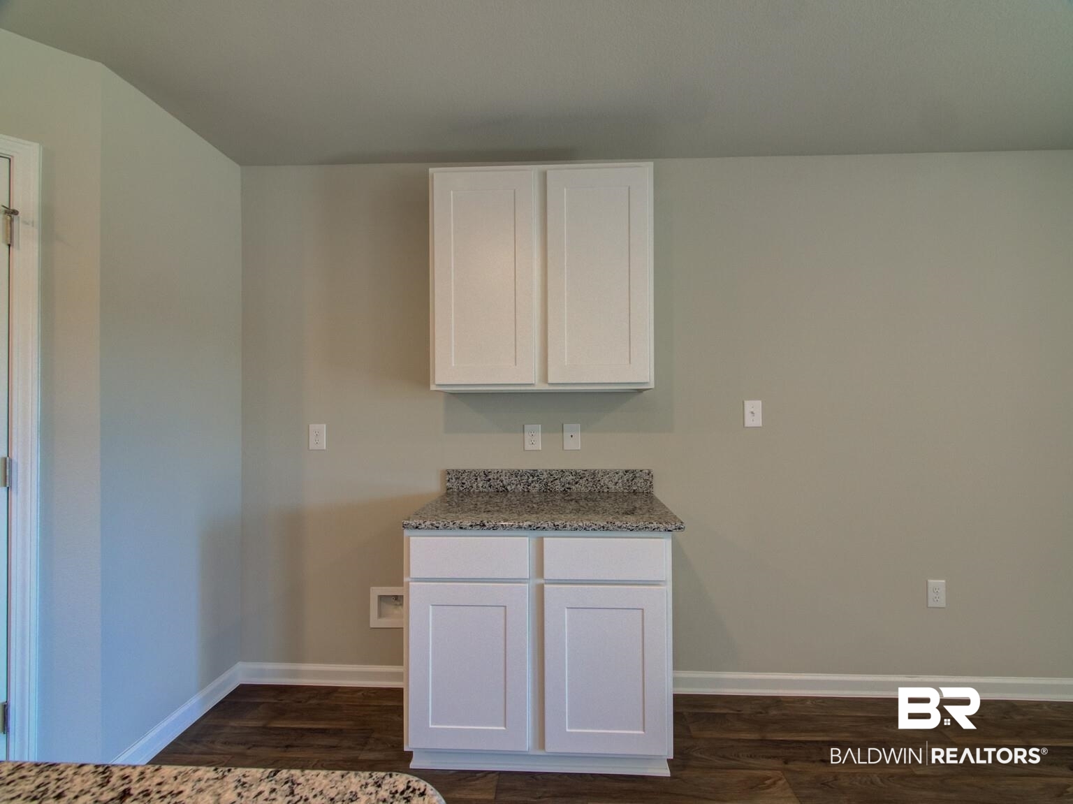23953 Citation Loop Daphne, AL 36526 - Photo 10 of 49 Kitchen with white cabinets, light stone countertops, and dark wood finished floors