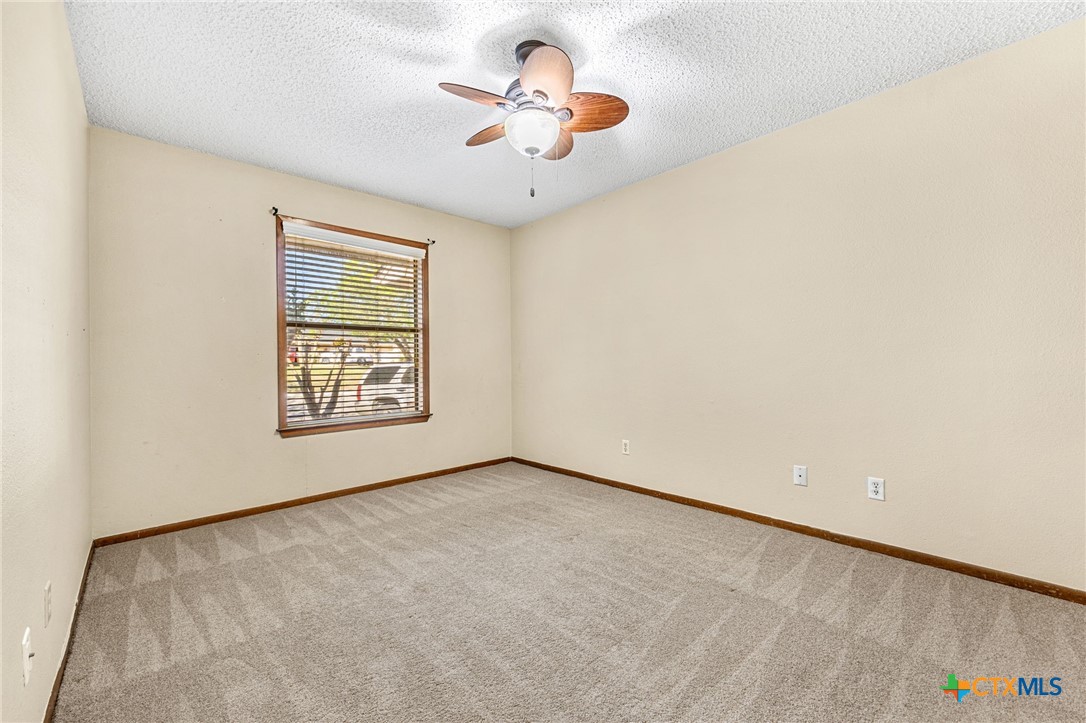 1015 Old Mill Road, Unit 4D Salado, TX 76571 - Photo 14 of 22 an empty room with windows and ceiling fan